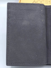 Close-up of a dark gray fabric surface with visible texture and stitching.