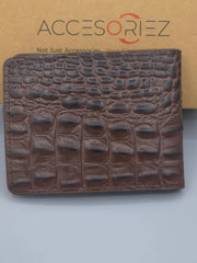 Brown textured wallet on a light gray background with 'Accesoriez' branding.