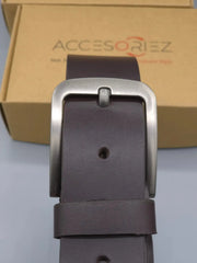 Brown leather belt with silver buckle in front of an Accesoriz box.
