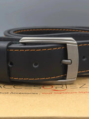 Black leather belt with silver buckle on a brand box
