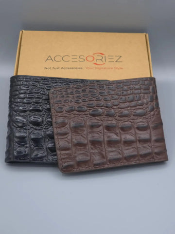 Two crocodile texture wallets in black and brown with an 'Accesorize' box in the background.