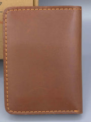 Brown leather wallet on a gray background