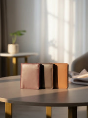 Two leather-bound books on a table with a blurred indoor background