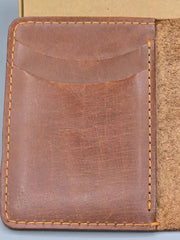 Brown leather wallet with visible stitching on a light gray background