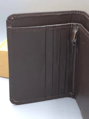 Brown leather wallet with a zipper on a white background