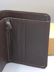 Brown leather wallet on a white surface