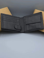 Black leather wallet on a gray surface with a neutral background