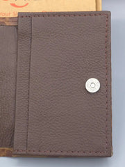 Brown leather wallet with a metal button on a light gray background