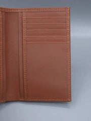 Brown leather wallet on a gray background
