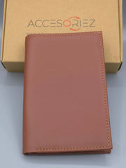 Brown leather wallet on a light gray surface with 'Accesoriez' branding in the background.