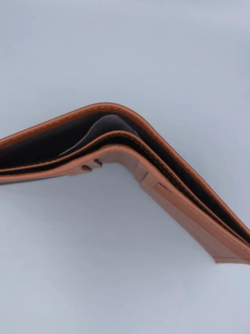 Brown leather wallet on a light gray background