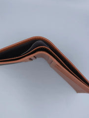 Brown leather wallet on a light gray background