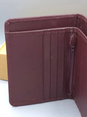 Brown leather wallet on a white surface