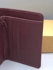 Brown leather wallet on a white surface with a neutral background