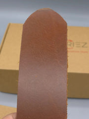 Brown leather sole with a visible brand name on a gray background