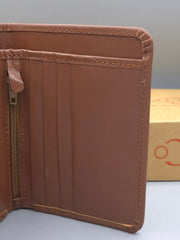 Brown leather wallet with a visible brand logo in the background