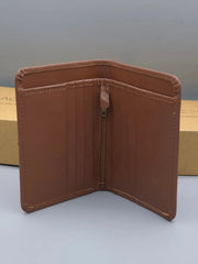 Brown leather wallet on a light gray background