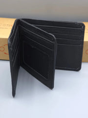 Black leather wallet on a white surface with a neutral background
