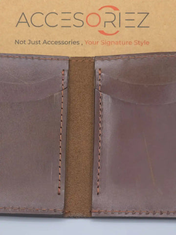 Brown leather wallet with visible stitching on a white background, featuring the Accesoriez brand.
