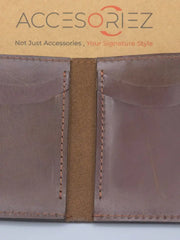 Brown leather wallet with visible stitching on a white background, featuring the Accesoriez brand.