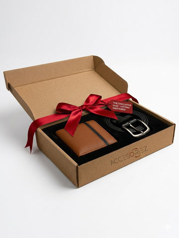 Brown leather wallet and belt set with a red ribbon in an open cardboard box on a light gray background.
